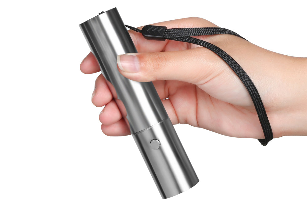 The Bullet Red Light Therapy Device Held With Strap